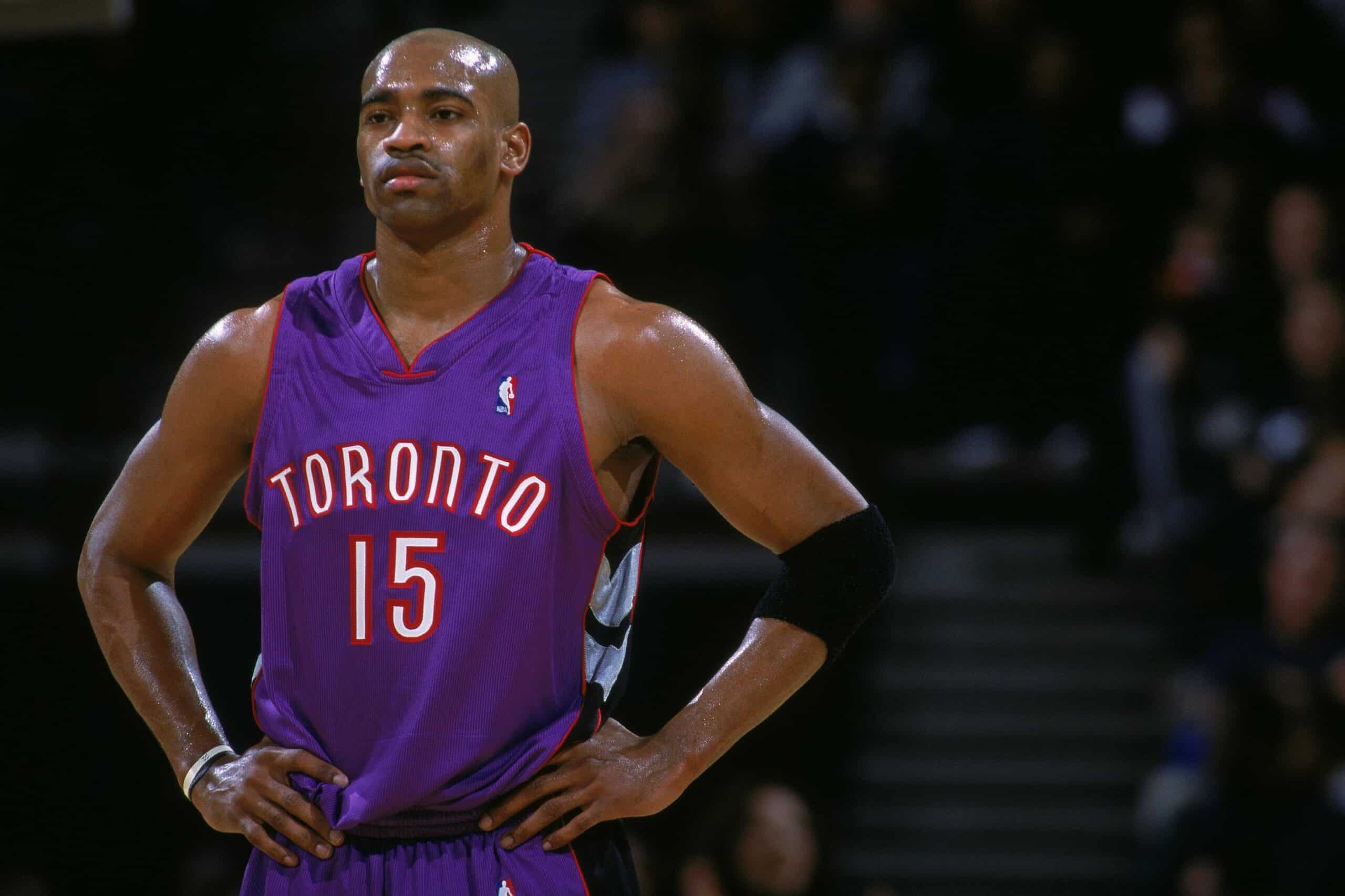 Vince Carter in a Raptors uniform hands by his hips