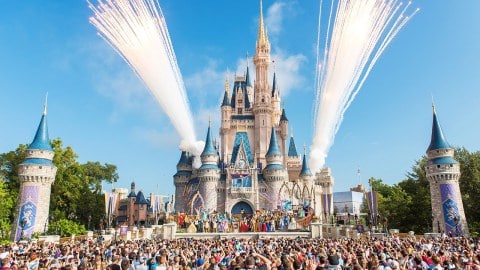 Walt Disney World Resort in Florida shooting fireworks with crowd and castles