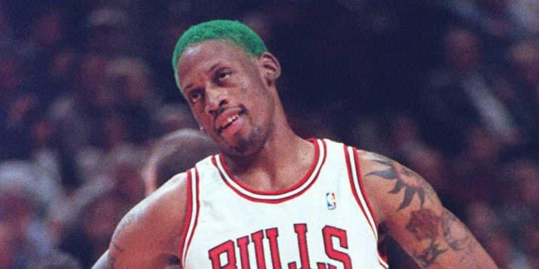 Dennis Rodman tilting his head Last Dance Documentary Las Vegas Bulls green hair blurred background